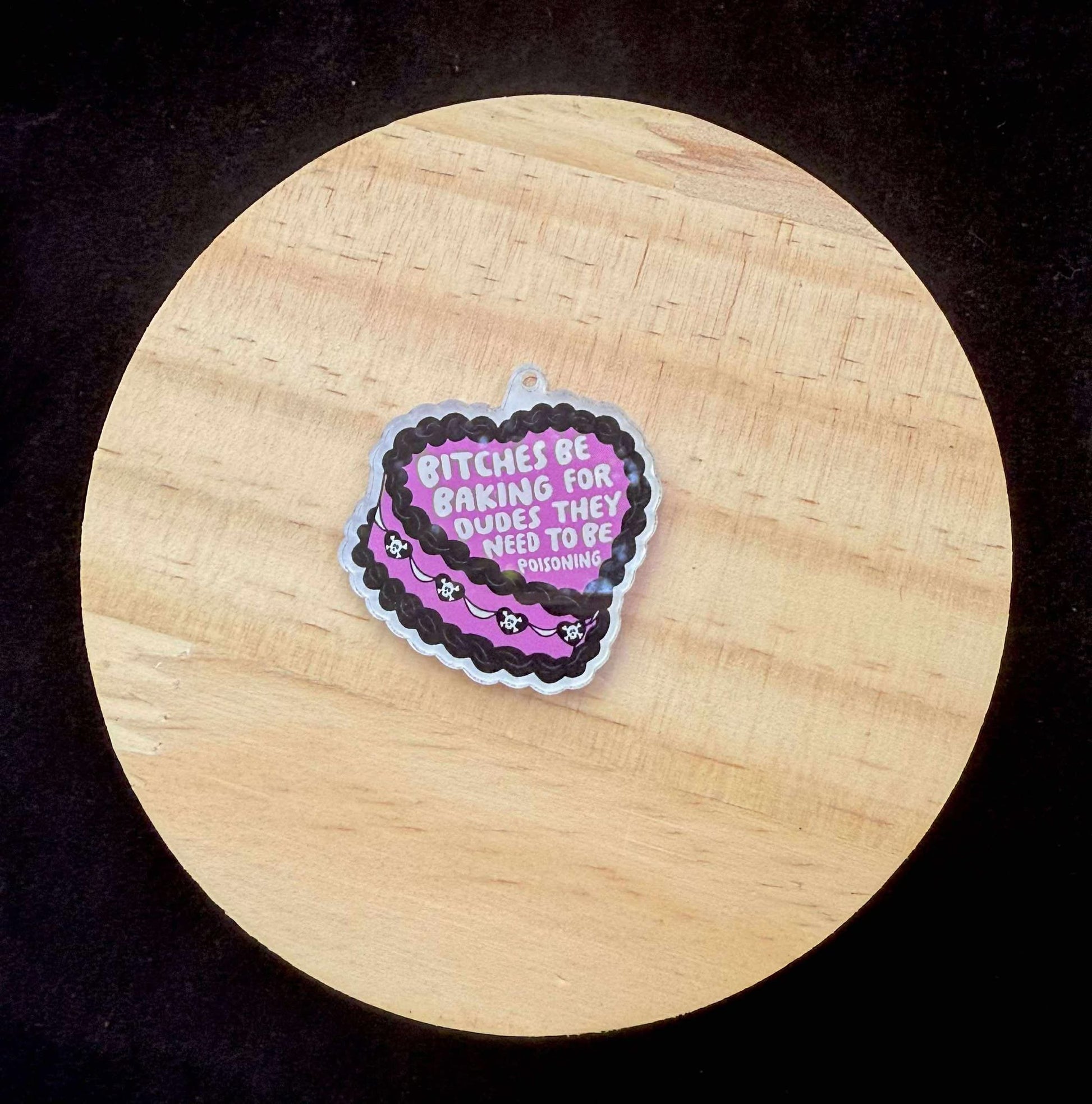 “Bitches Be Baking for Dudes They Need to Be Poisoning” Dust Plug Charm – With Keyring & Clasp (iPhone, USB-C, Micro USB)