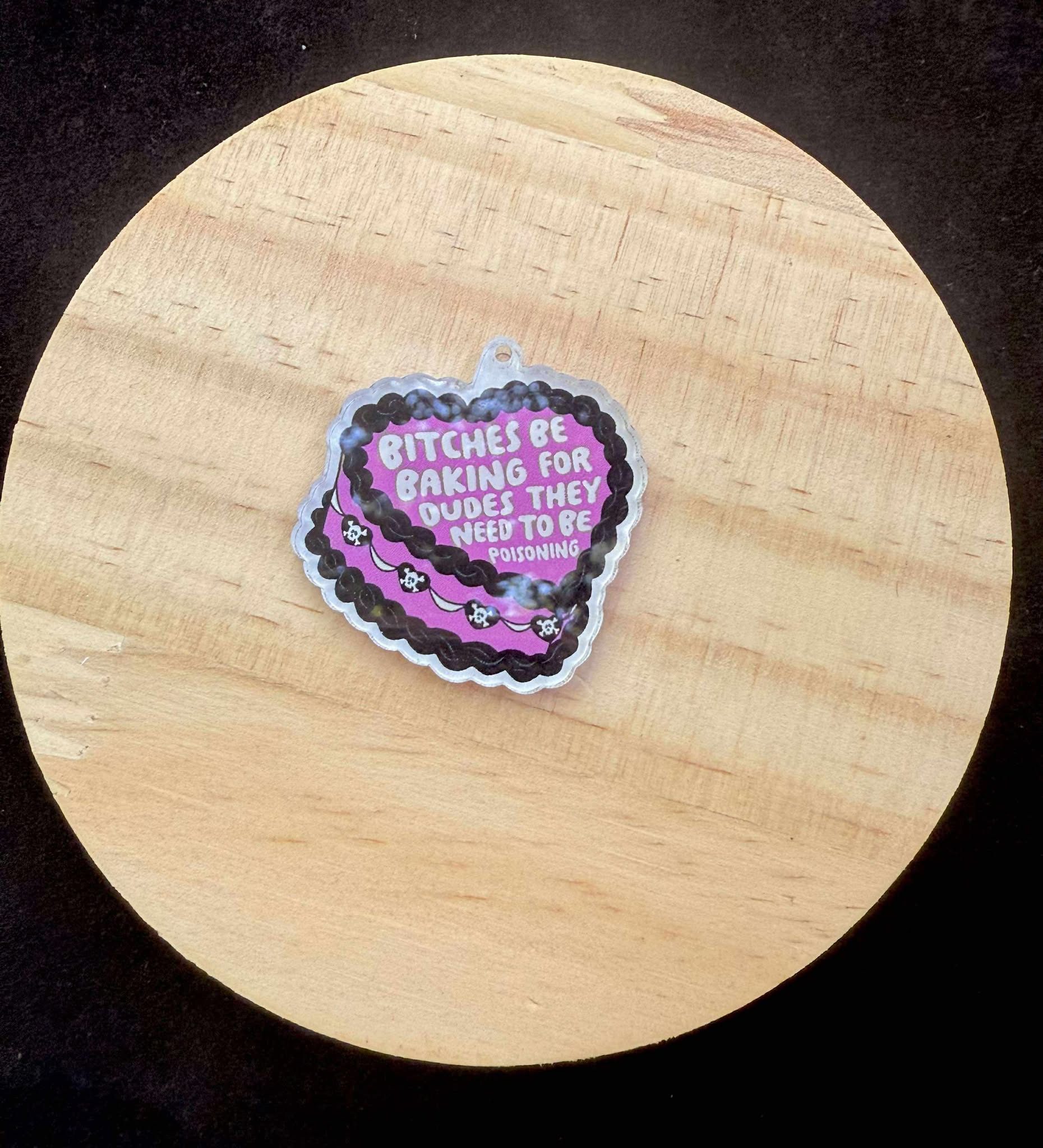 “Bitches Be Baking for Dudes They Need to Be Poisoning” Dust Plug Charm – With Keyring & Clasp (iPhone, USB-C, Micro USB)